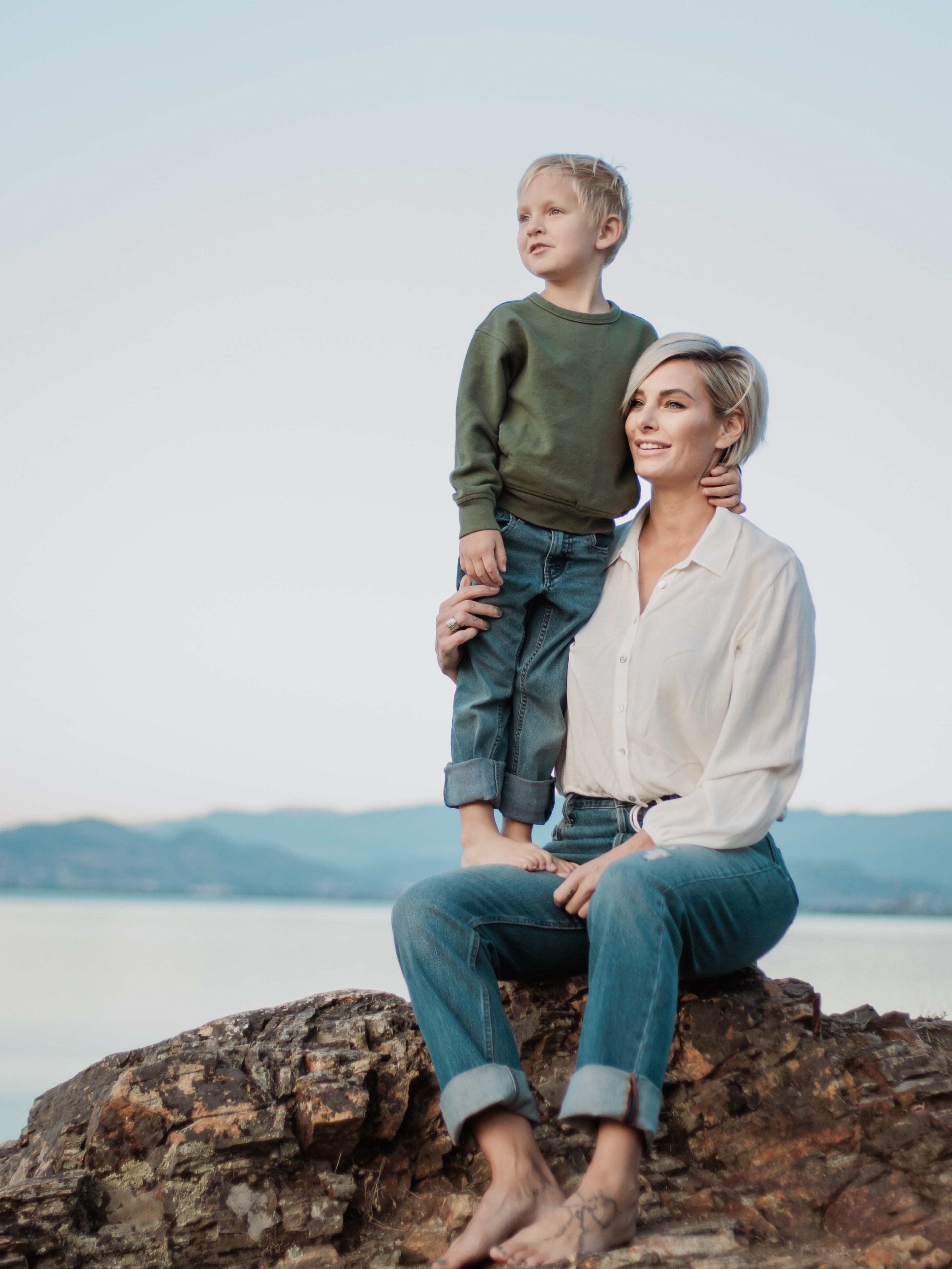 Nicole D. Mychasiuk, founder of The Ever Collective, with her son by the water in Kelowna, BC